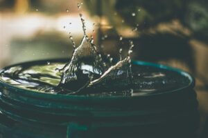 Water dropping into a bucket, creating a joyous splash.